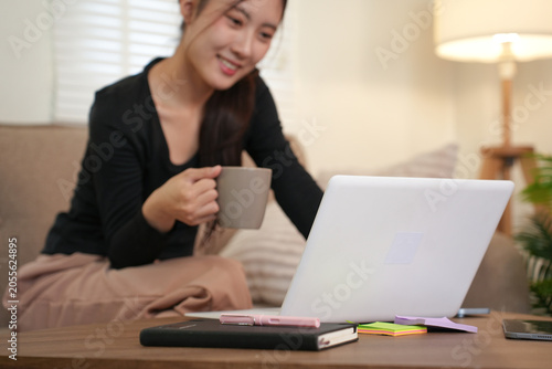 Woman Celebrating Success While Using Laptop