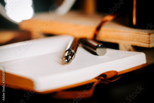 Open notebook with a silver pen on blank pages ready for writing