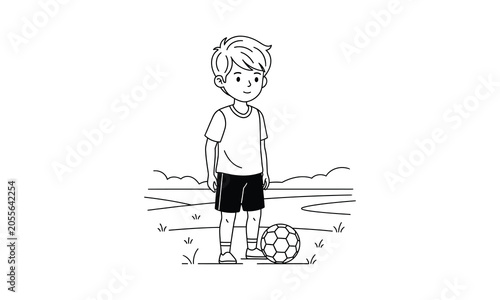 A young boy standing with a soccer ball on a field looking happy and ready to play