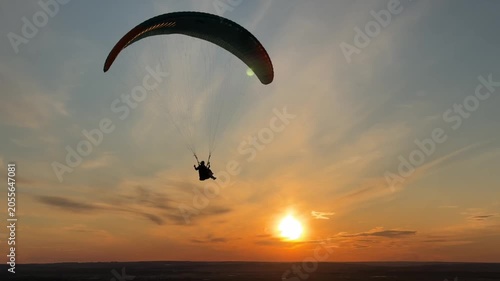 Tandem paragliding at the sunset