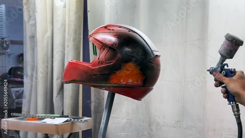 airbrushing a red motorcycle helmet