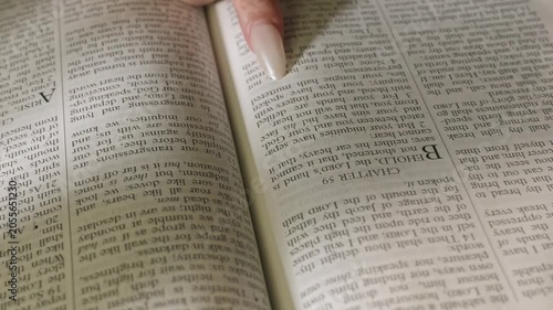 young conservative asian Woman Reading the Bible at table with bread food and drink indoors