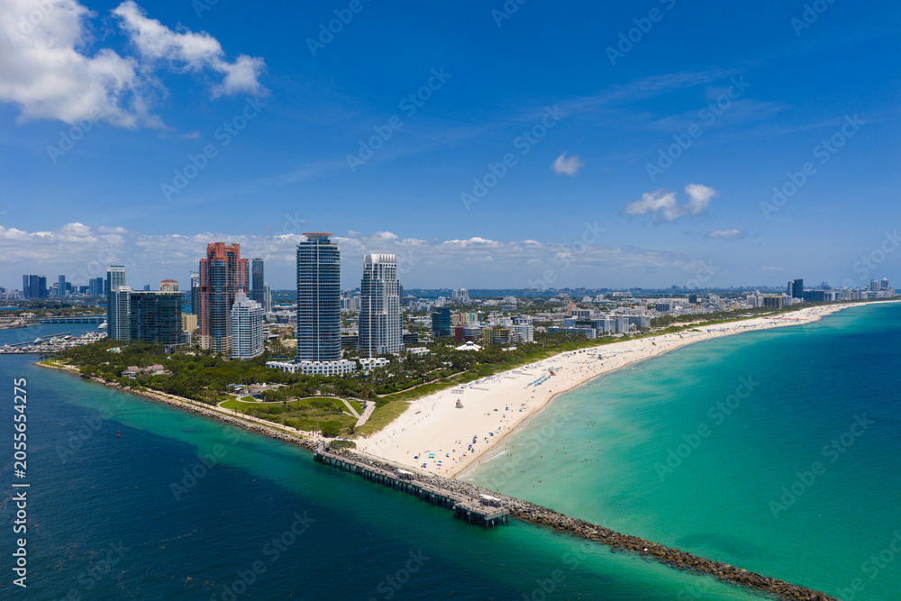 Obraz premium Miami cityscape with luxury skyscrapers and ocean. Panoramic drone view of Miami coastline. Miami Beach from above. Miami skyline from top.