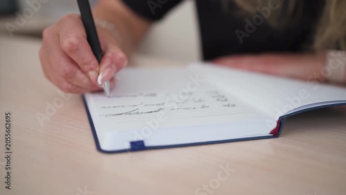 Woman Journaling Personal Thoughts in Notebook