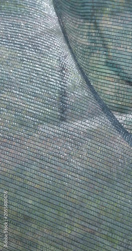 Green garden shade net moving in the wind