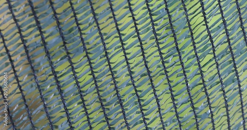 Close up of green plastic safety net swaying in the wind
