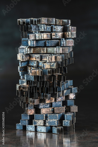 Oxidized nonferrous metal sheet components covered with natural patina and arranged in an abstract stack on a metal surface, metallurgy, recycling and industrial material processing