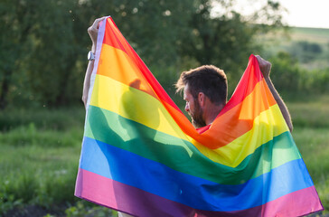 couple holding rainbow flag for pride month