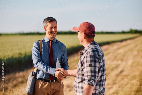Fotografie Happy insurance consultant came to agreement with farm owner.