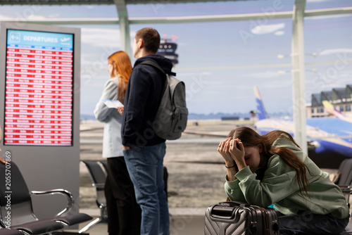 Quadro su tela Remote worker react to postponed flights and shutdown conditions, staring at cancellation notice in crowded airport lounge, Diverse travelers illustrating upset emotions and panic
