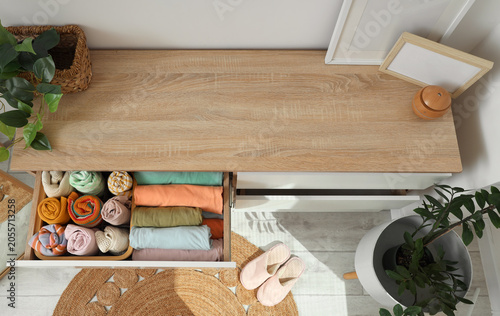Quadro em tela Organized clothing drawer with rolled and folded garments, home storage solution