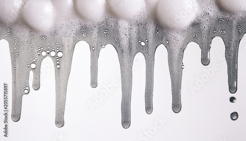 vertical streams of white soap foam with tiny bubbles dripping texture on white background ideal for hygiene skincare product packaging and cleaning concept design visuals