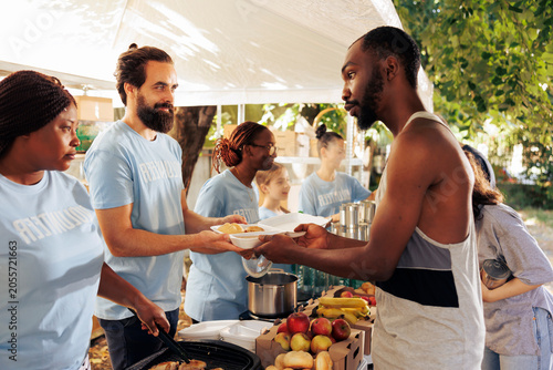Tableau sur toile Voluntary team at food bank, providing a compassionate effort to alleviate poverty and offer humanitarian aid, with homeless, refugees, and the needy receive meals and donations from generous