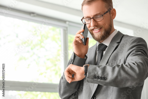 Smiling businessman in gray...