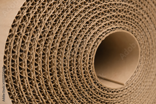 Corrugated cardboard roll close up, brown recycled paper packaging material, industrial fluted fiberboard texture for shipping and logistics isolated on White Background ai