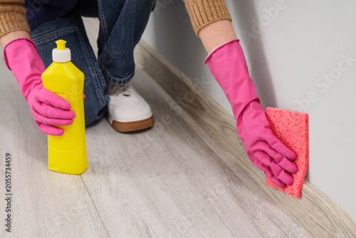 Person in pink gloves clean...