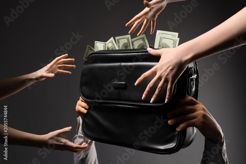 Fotografie Hands reaching for money in briefcase, financial greed and corruption, business