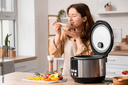 Young woman tasting healthy...