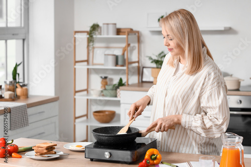 Blonde woman cooking health...