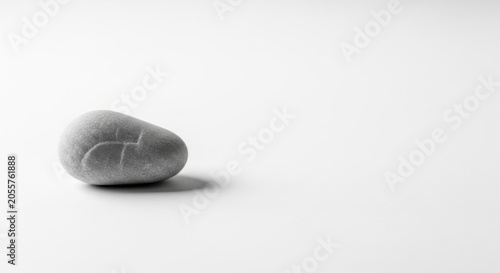 Smooth pebble stone on clean white floor.