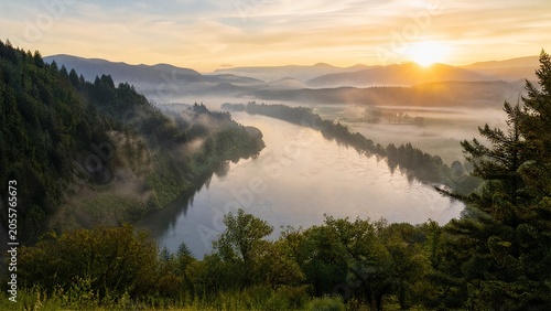 Willamette River winding through misty Oregon valley at sunrise.