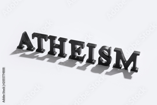 Atheism word in black block letters on white background, philosophical belief system and non-religious worldview, this visual illustrates the of non-religious worldview and secular thought