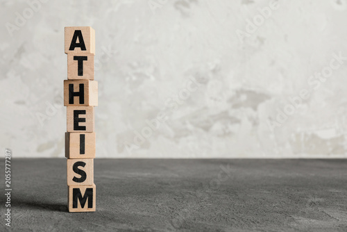 Photography Atheism word spelled with wooden blocks philosophical belief system non-religiou