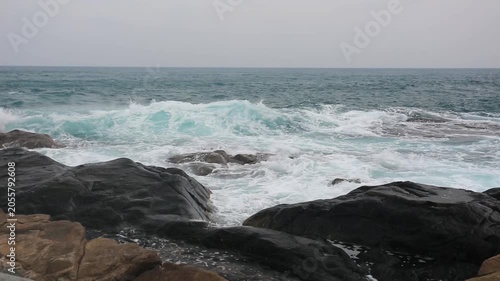 Huge waves crashing against the rocks。Stone Park Scenic Area, Hainan, China