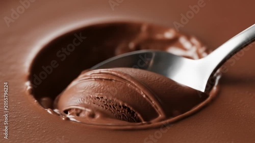 Scooping Delicious Chocolate Ice Cream with a Spoon.