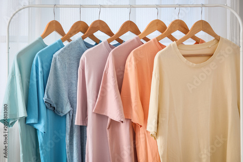 Colorful t-shirts on wooden...