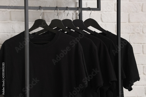 Multiple black t-shirts on ...