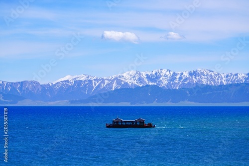 A cruise ship in the middle of the Blue River Lake in Sailimu Lake, Xinjiang, China
