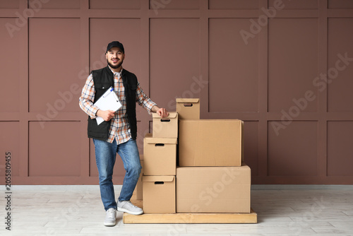 Smiling delivery man with c...