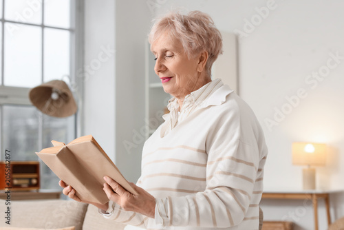 Beautiful senior woman read...