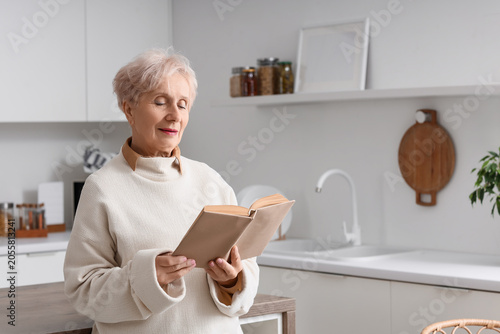 Beautiful senior woman read...
