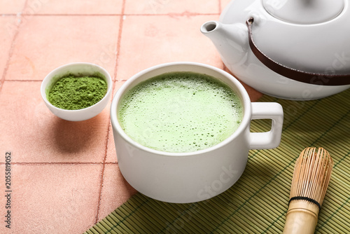 Cup of matcha tea with powd...