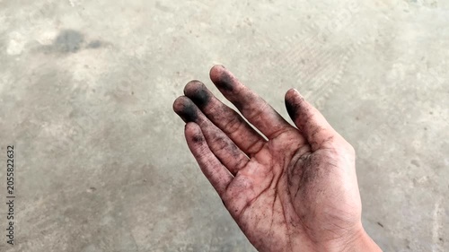Dirty hands covered in black oil stains after work. The concept of hardworking, mechanical, industrial, and automotive workers