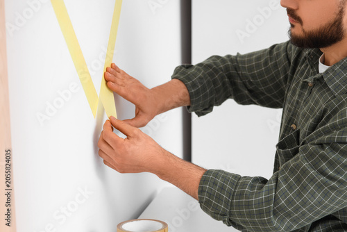 Young man applying masking ...