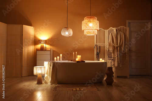 Konstfotografi Relaxing bathroom interior with bathtub, warm lighting, and candles for spa and