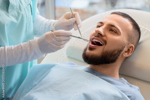 Young man visiting dentist ...