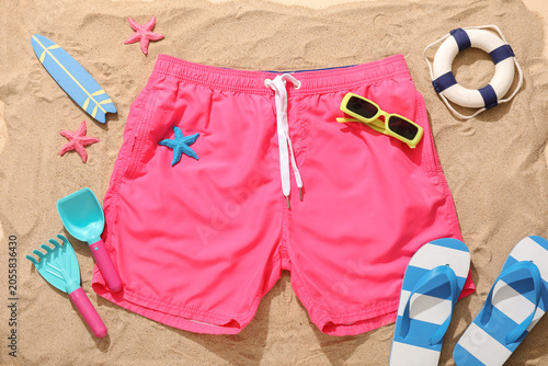 Pink swim trunks with beach...