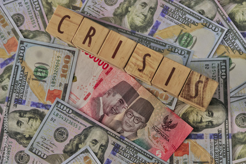 Indonesian Rupiah banknote and US Dollar bills for currency exchange illustration of crisis. its depreciation IDR vs USD money for finance concept with detail shot