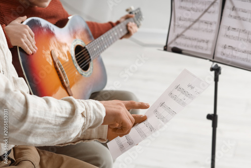 Adult hand pointing at musi...