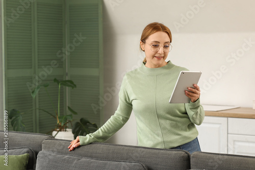 Mature woman using digital ...