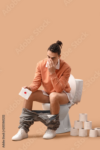 Young man with hemorrhoids ...