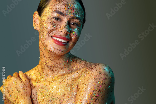 Smiling woman covered in gl...