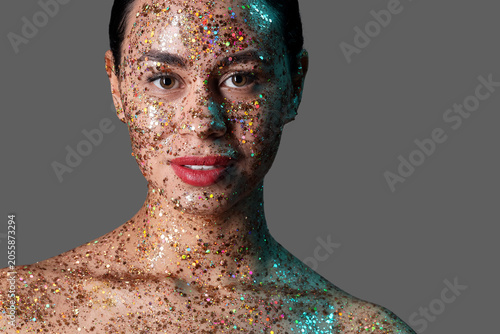 Young woman with glitter ma...