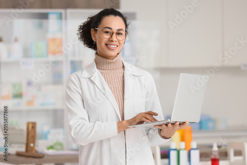 Smiling female pharmacist i...