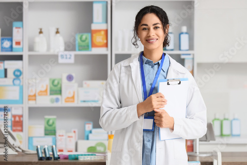 Smiling female pharmacist h...