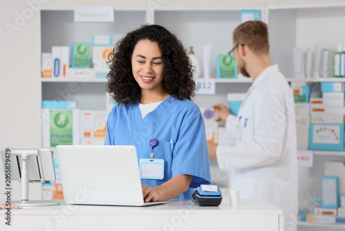 Smiling female pharmacist i...
